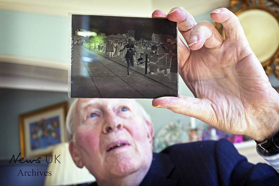 Sir Roger Bannister at home in Oxford. Here looking at a glass plate negative of a photo of him crossing the finishing line in his at the time record breaking sub four minute mile. Jack Hill/The Times/10 April 2014